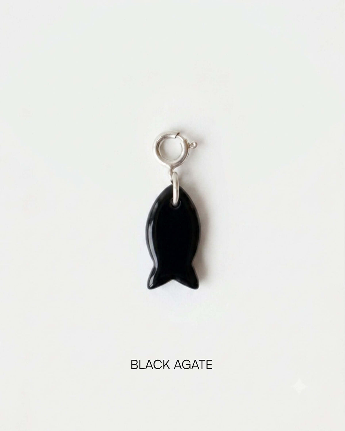 Fish Charm Small made of Black Agate, featuring a sleek fish design, ideal for versatile styling.